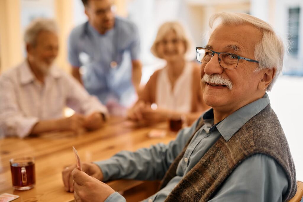 Carrollton Gardens | Senior Man Playing Poker With His Friends