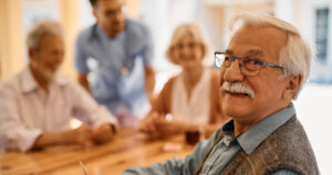 Carrollton Gardens | Senior Man Playing Poker With His Friends